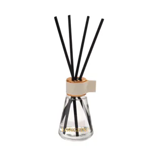 Glass reed diffuser set with black sticks and white leather ring for home fragrance decor.