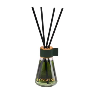 Detailed close-up of a glass reed diffuser bottle with green liquid and black reeds.