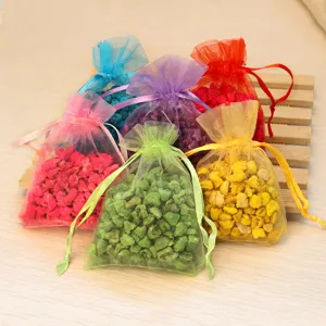 Colorful organza bags filled with scented stones, aroma sachet packets for car and home decor.