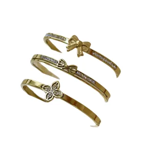 Eleganti bracciali in acciaio al titanio dorato con fiocco di cristallo e fiori per donna