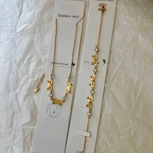 Exquisite detail of bowknot necklace and bracelet set in 18K gold plated stainless steel.