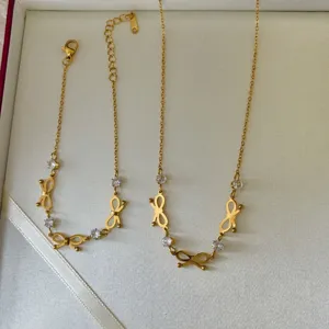 Close-up detail of 18K gold-plated stainless steel bow-knot jewelry set with crystals