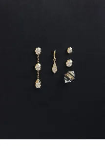 Close-up of vintage minimalist gold earrings and sparkling zircon drops