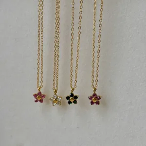 Detailed macro view of 18k gold-plated titanium steel flower necklaces with multi-color stones