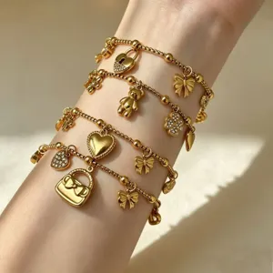 Vergulde roestvrijstalen bedelarmbandset met vlinder-, hart- en klavertjevierhangers