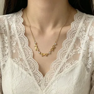 Elegant 18K gold plated stainless steel necklace with bow and rhinestones