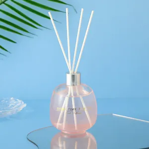 Pink bubble glass bottle reed diffuser with white sticks for home fragrance and decor.