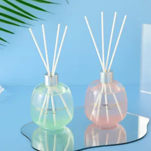 Glass bubble reed diffuser bottle with colorful liquid and sticks for home decor fresh scent.