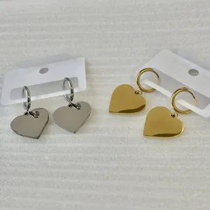 Detailed view of stainless steel heart hoop earrings in gold and silver finishes