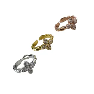Adjustable twisted copper rings with zircon four-leaf clover floral design in three colors.