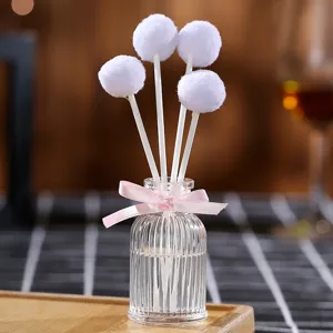 Aromatherapy diffuser bottle with white fluffy balls and pink bow for home bedroom decor main view