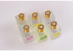 Square glass diffuser bottles set with gold caps, perfect for home fragrance and aromatherapy.