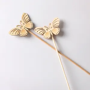 Detail view of wooden butterfly craft sticks, natural wood texture laser cut decorative picks.