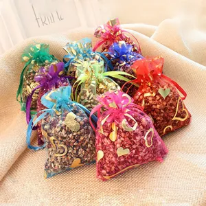 Colorful organza sachets filled with dried grains and flowers, perfect for home wardrobe freshening.