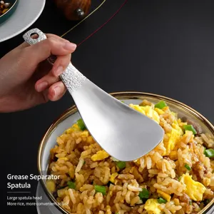 Stainless steel rice spoon with rock textured handle, non-stick serving paddle for home kitchen.