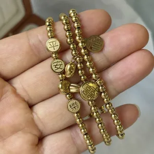 Dettaglio del bracciale di 3mm in acciaio dorato con ciondoli portafortuna cinesi