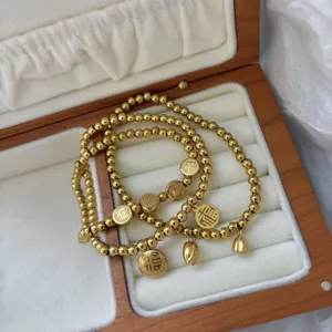 Bracciali elastici con perline in acciaio inossidabile dorato da 3mm e ciondoli cinesi