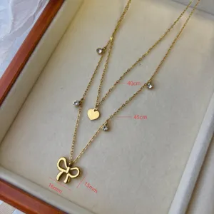 Detailed view of layered bow and heart necklace with 40cm and 45cm chain length dimensions