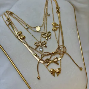 Elegant gold-plated multi-layer bow necklace set decorated with shiny cubic zirconia