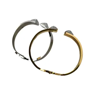Wide stainless steel pyramid cuff bracelet with sparkling pavé crystals in gold and silver