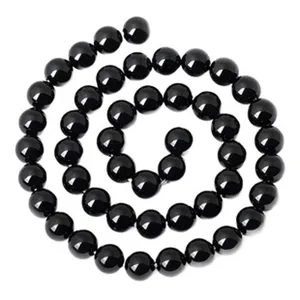 Black round beads for jewelry making, smooth surface, elegant spiral display design.