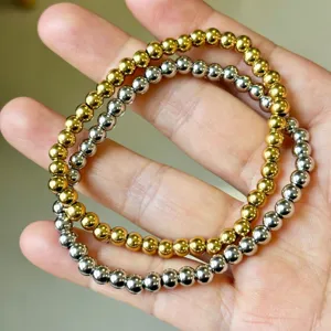 Elegant stackable gold and silver metallic elastic bead bracelet set in high-polish finish