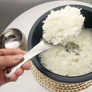 Stainless steel rice spoon with hammered handle, durable non-stick rice paddle for kitchen use.