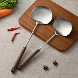 Stainless steel wok spatula with wooden handle for home cooking and chef kitchen tools.