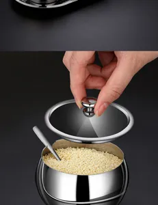 Detailed view of hand lifting lid from 304 stainless steel seasoning jar with granules