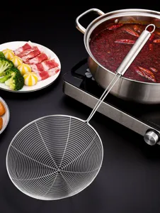 Detail view of stainless steel hot pot skimmer with fine mesh and long handle.