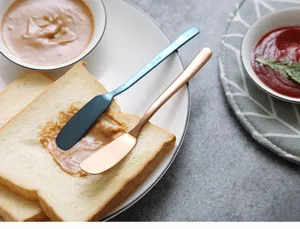 Stainless steel butter knife detail showing smooth spreader blade for jam and cream spread.