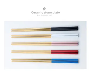 Stainless steel chopstick detail showing colorful handles and gold tips in a neat flat lay.