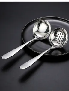 Stainless steel soup spoon and slotted spoon set, long handle detail view, mirror polished.