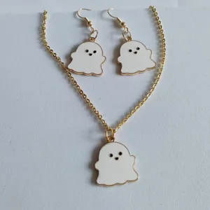 Close-up of Halloween ghost jewelry set with gold necklace and matching drop earrings.