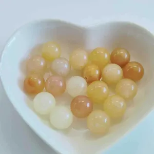 Natural gemstone crystal round beads detail shot, smooth polished surface, DIY jewelry.
