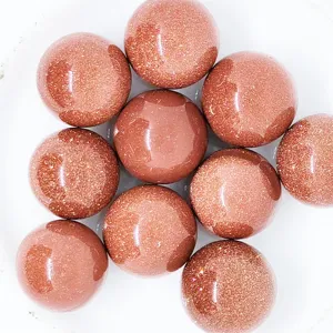 Close-up detail of glittering brown goldstone sphere beads, perfect for crystal jewelry DIY.