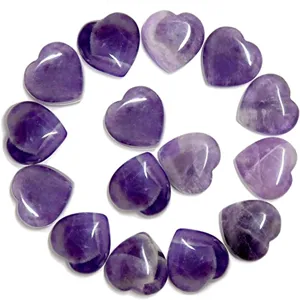 Detail view of natural amethyst crystal heart shaped gemstone pocket stone decor for gifts.