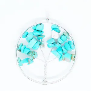 Detailed view of a handmade tree of life pendant wire wrapped with turquoise stone chips.