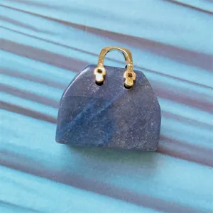 Natural stone crystal mini handbag pendant detail close-up showcasing unique blue gemstone craft.