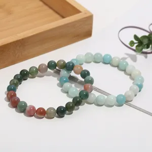 Natural crystal agate gemstone bead bracelet detail view showing polished surface and vibrant colors.
