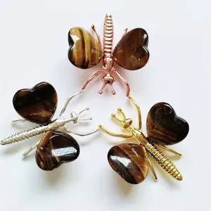 Natural stone butterfly and dragonfly ornament detail showing metal and crystal heart wings.