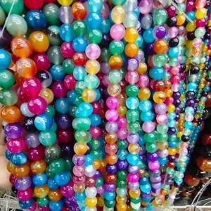Detailed close-up of colorful striped agate beads for DIY handmade jewelry crafting.