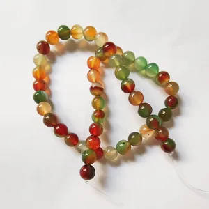 Close-up detail of multi-color striped agate gemstone round beads for DIY handmade jewelry.