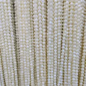 Close up of natural white shell loose beads with pearlescent luster, perfect for jewelry making.