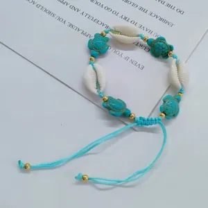 Bohemian natural shell woven bracelet with turquoise turtle beads and adjustable cord beach style.