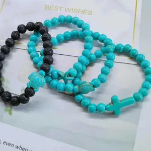 Close-up of turquoise beads with sea turtle and starfish charms on elastic bracelets
