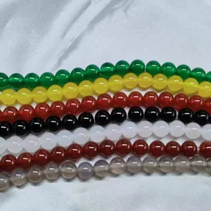 Close-up detail view of colorful polished agate gemstone loose beads for creative DIY jewelry.