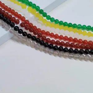 Detail view of colorful natural agate loose beads strands, smooth round stones for DIY jewelry.