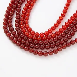 Close-up detail of natural red agate round beads DIY jewelry making semi-finished bracelet strand.