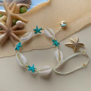 Bohemian shell bracelet with turquoise starfish and gold beads, beach vacation style jewelry.